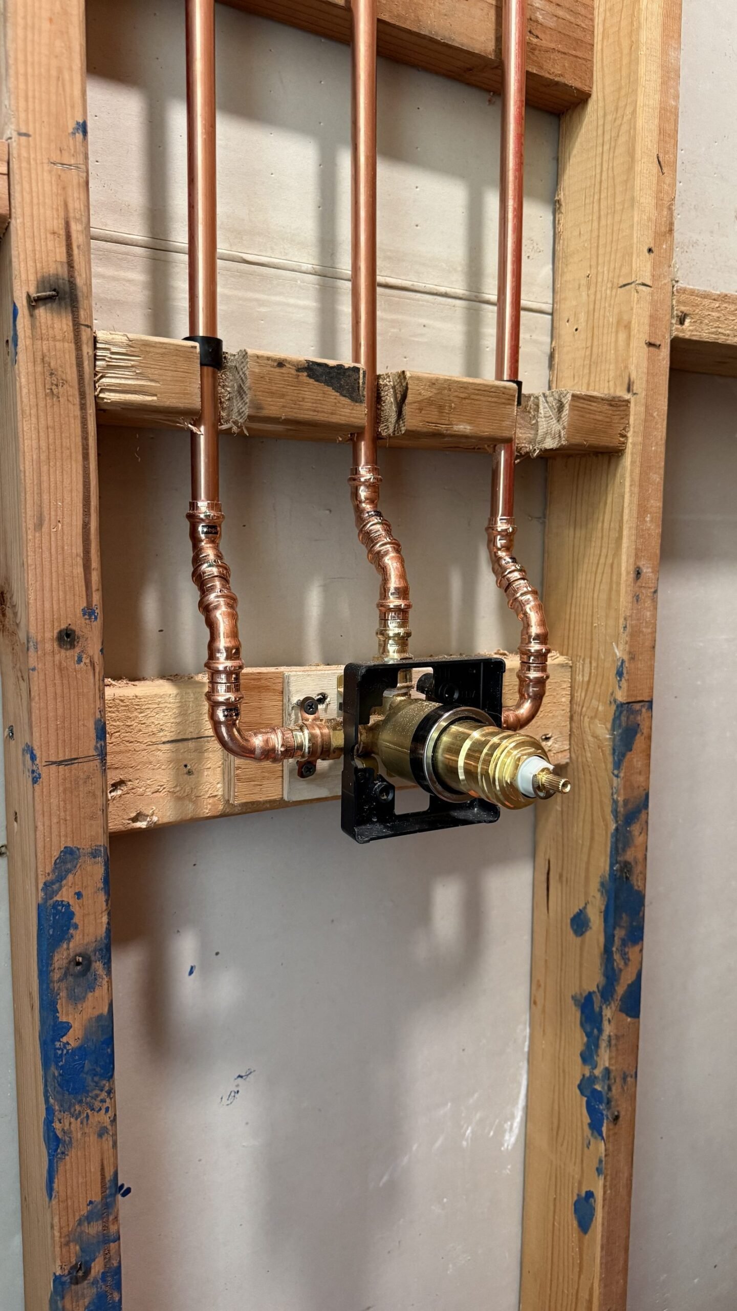 Copper plumbing rough-in for the shower valve during the primary bathroom remodel