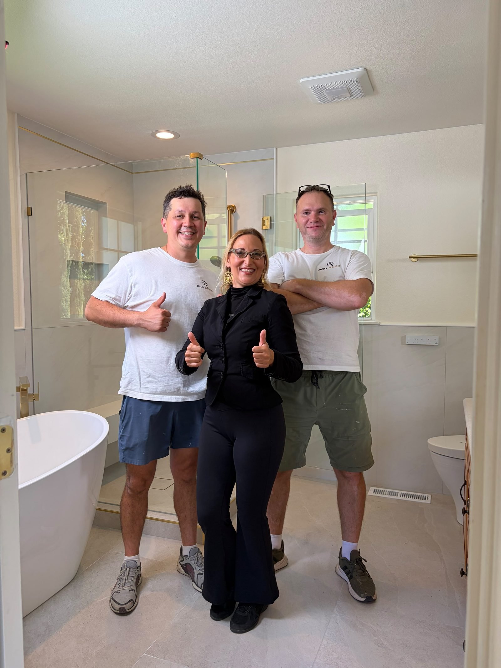 Pro Rock Construction team with the client after completing the primary bathroom remodel